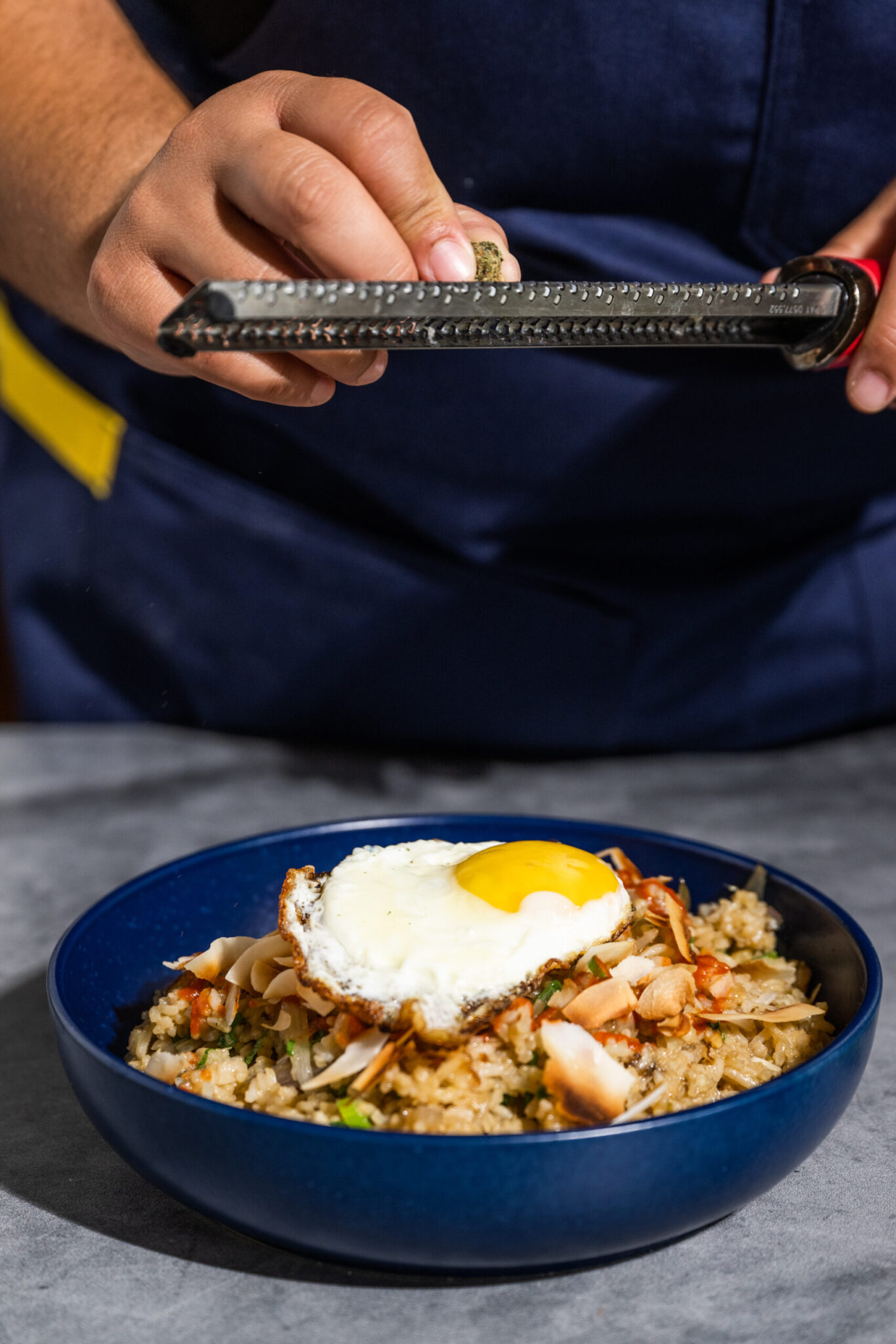 Bowl of cannabis infused fried rice topped with a fried egg